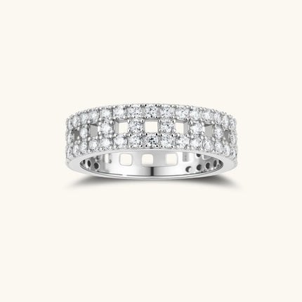 Wide sterling silver ring with three rows of brilliant moissanite stones in geometric pavé setting on white background