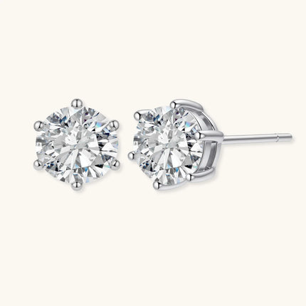 Close-up of round brilliant-cut moissanite stud earrings in 6-prong sterling silver settings showing exceptional sparkle
