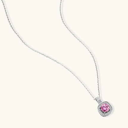 Sterling silver necklace with cushion-cut pink moissanite in diamond halo setting on white background