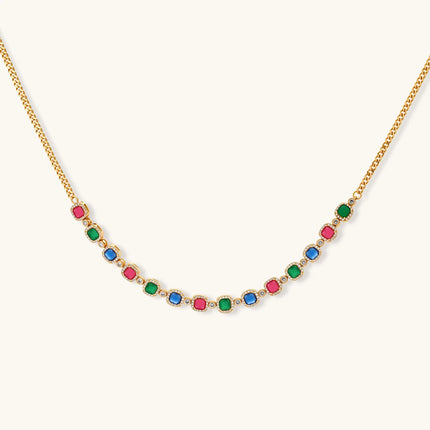 Gold-plated jewelry set with red, green, and blue cubic zirconia stones including necklace, bracelet, and drop earrings.