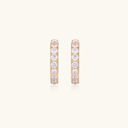 Gold pavé hoop earrings with two freshwater pearls nestled inside the curved design, featuring crystal-studded outer edge.