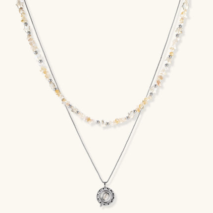 Complete jewelry set featuring citrine stone chips, silver beads, and cosmic circle pendants on cream background.