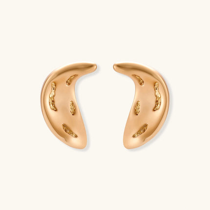 Gold-toned crescent moon pendant with textured surface on black adjustable cord, displayed with matching crescent earrings