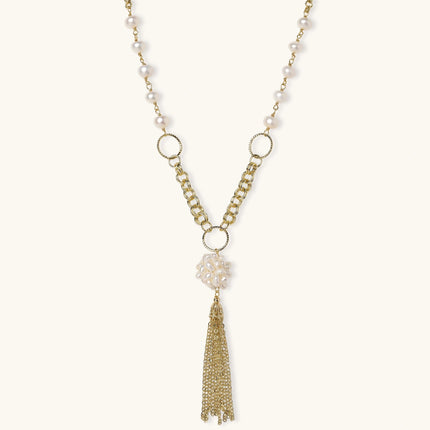 Long gold-plated necklace with freshwater pearls, chunky chain links, and flowing tassel pendant