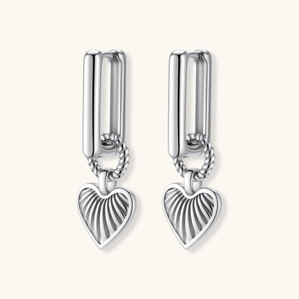 Platinum-plated 925 sterling silver rectangular hoop earrings with twisted ring connector and ribbed heart charm pendant.