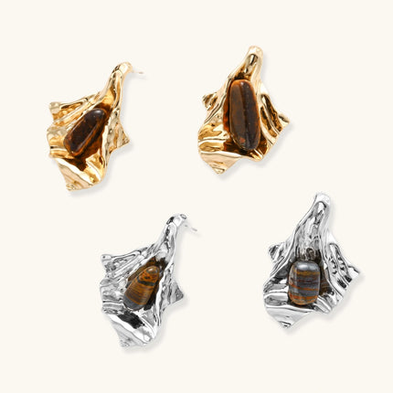 Silver sculptural earrings with flowing molten forms and amber gemstones, featuring 925 silver posts on white background.