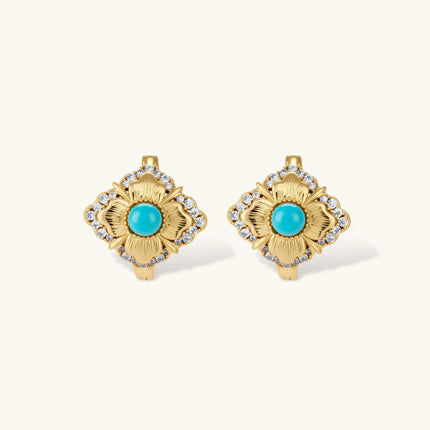 Close-up of 18K gold plated hoop earrings with turquoise center stones and zircon crystals in quatrefoil flower design