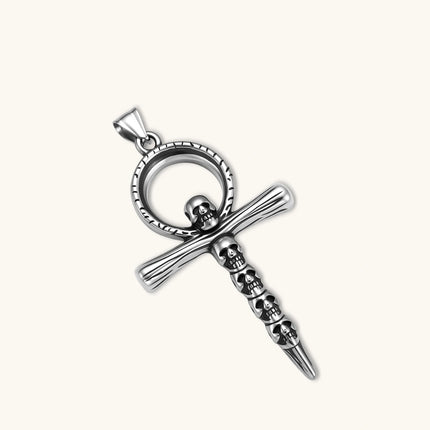 Silver stainless steel ankh pendant with skull motifs on vertical bar and textured ring top, on a box chain necklace.