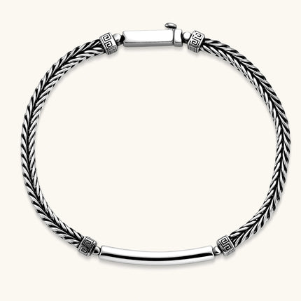 Silver stainless steel men's bracelet with braided foxtail chain, Greek key engraved bar, and decorative cube connectors.