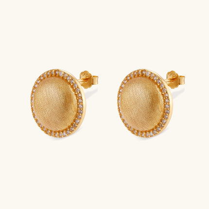 Pair of round dome stud earrings in brushed 18K gold-plated silver with a sparkling CZ halo border, push-back closure.