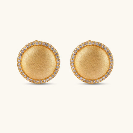 Pair of round dome stud earrings in brushed 18K gold-plated silver with a sparkling CZ halo border, push-back closure.