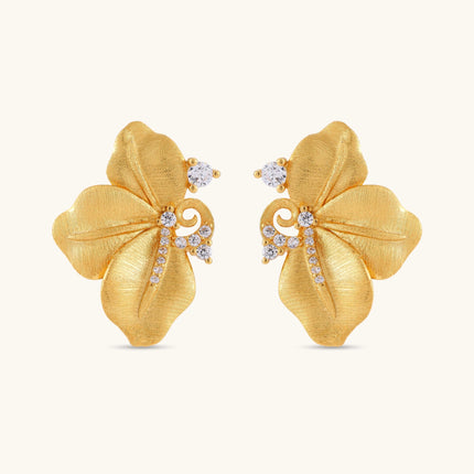 Gold-plated 925 silver flower stud earrings with brushed finish, swirl detail, and pavé cubic zirconia on cream background.