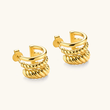 Gold-plated sterling silver triple hoop huggie earrings with rope-twist and smooth band details, shown from front and side.